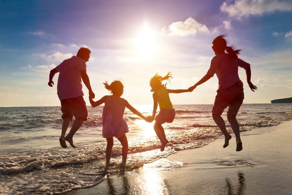 Family playing joyfully at beach